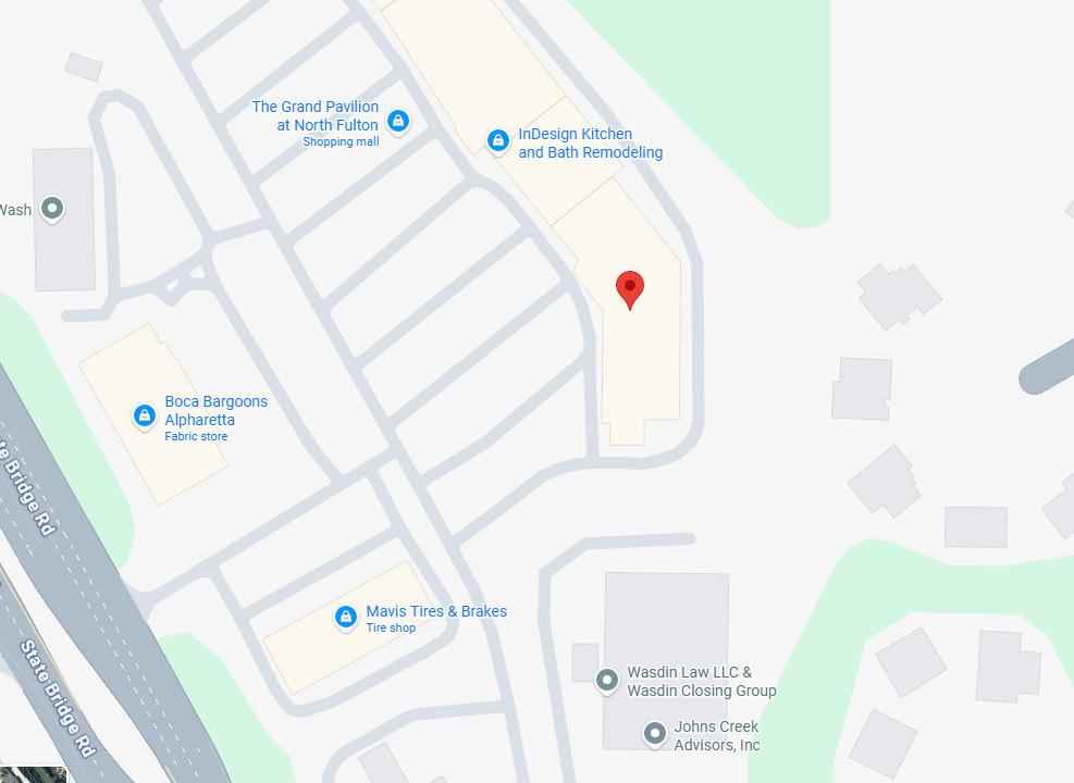 Map view with a red pin marking a building in a curved driveway within a shopping center